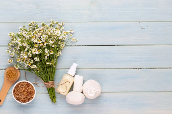 Sea salt, aromatherapy oil in bottles and chamomile on vintage w — Stock Photo, Image