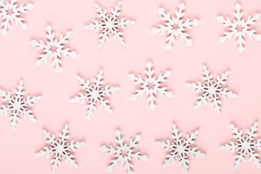Noel arkaplanı. Beyaz kar süslemeleri pembe bir sırtüstü
