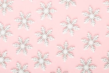 Noel arkaplanı. Beyaz kar süslemeleri pembe bir sırtüstü