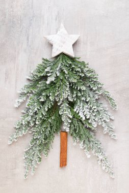 Noel ağacı, gri arka planda yatıyordu. Yeni yıl konsepti. Uzayı kopyala Düz yatıyordu. Üst görünüm.