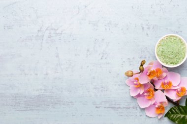Spa aromaterapi arka planı, basit orkide çiçekleriyle süslenmiş çeşitli güzellik ürünleri..