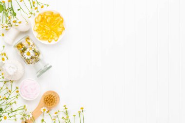 Doğal kozmetik ürünleri ve açık arkaplanda papatya çiçekleri ile kompozisyon aroması.