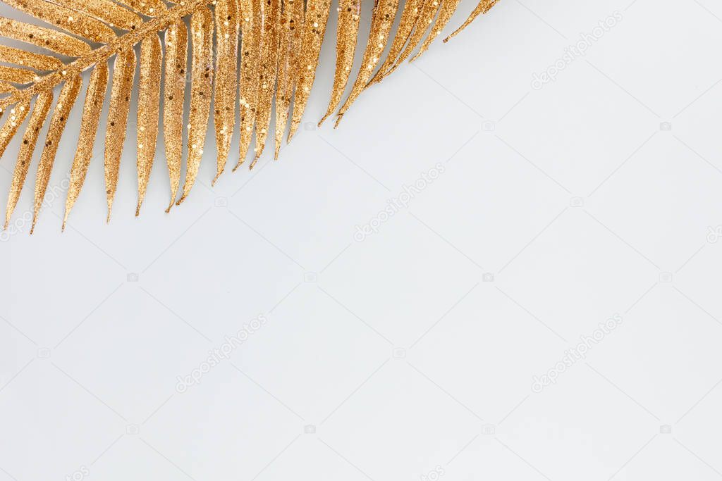  Palm gold leaf on blue background. Palm leaf, Flat lay and top view.