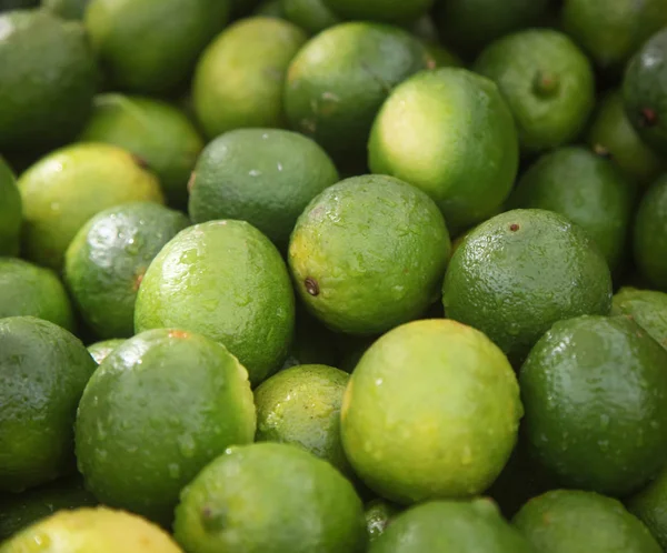 fresh green limes on the fruit market
