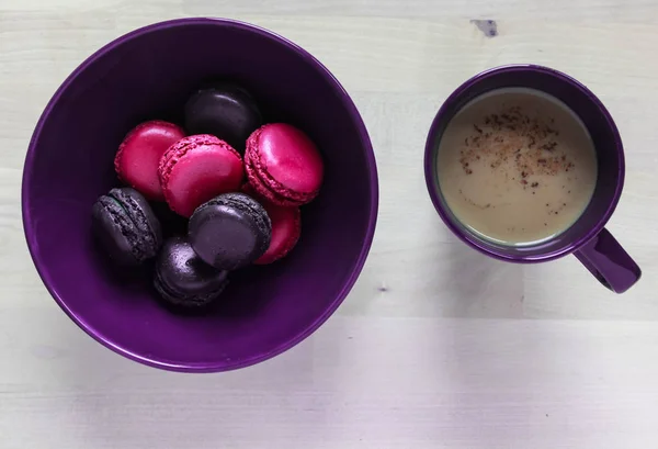 Pink and purple cookies pasta in a plate and a Cup of coffee
