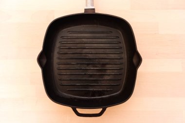 Ahşap arka planda yağsız tava, üst görünüm