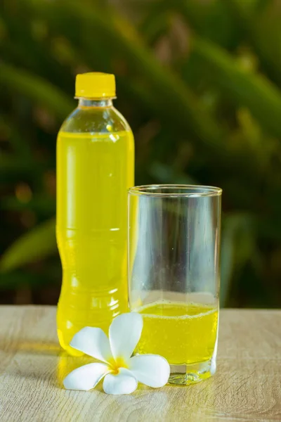 bottle with drink stand on a table on a green background