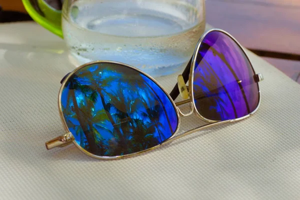 close up of sun glasses on wooden table