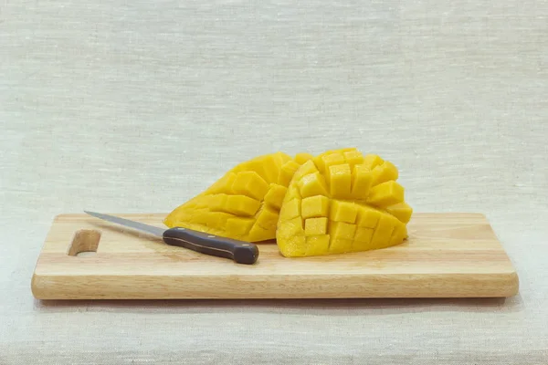 The mango fruit is cut into cubes on  background