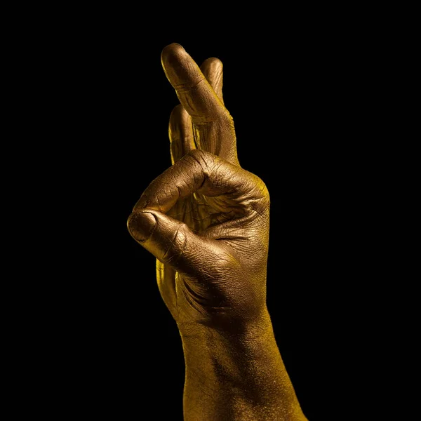 Golden hand and gesture on a black background