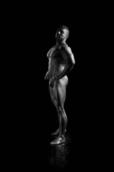 Black and white portrait Male bodybuilder posing on a white background. Photo made in the style of \
