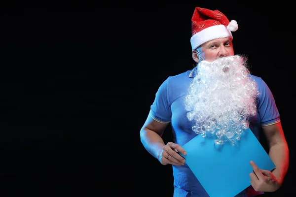 portrait actor male in cap and beard of Santa Claus on a black background