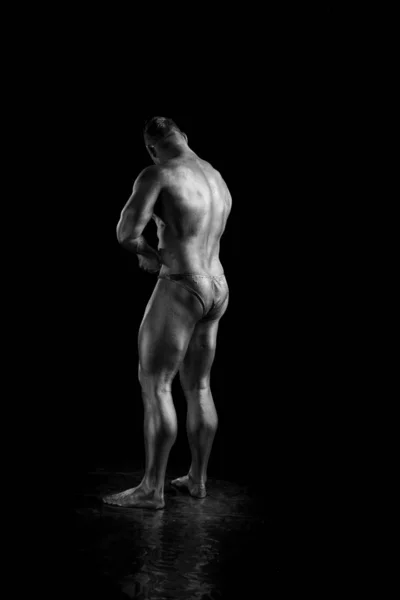 Black and white portrait Male bodybuilder posing on a white background. Photo made in the style of \