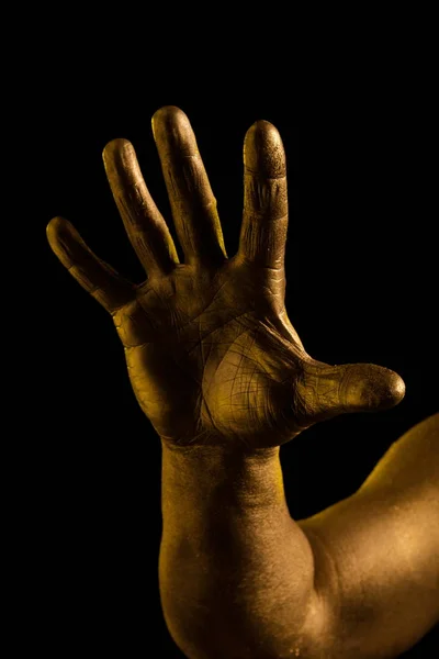 Golden hand and gesture on a black background