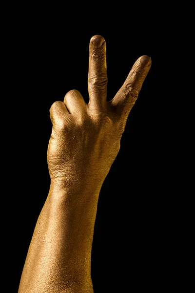 Golden hand and gesture on a black background