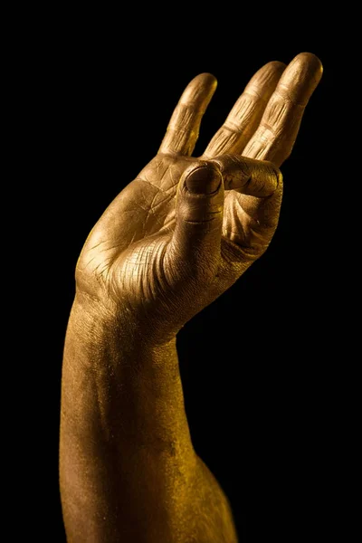Golden hand and gesture on a black background