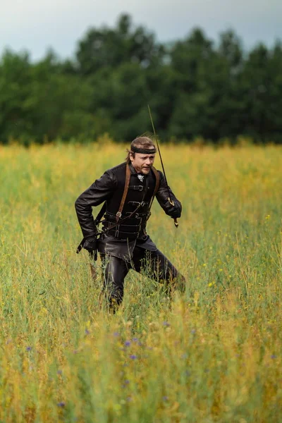 Man actor in the historical leather costume of a knight from the fantasy games