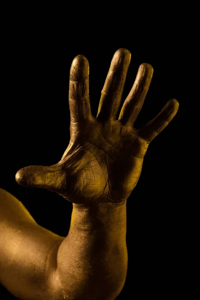 Golden hand and gesture on a black background