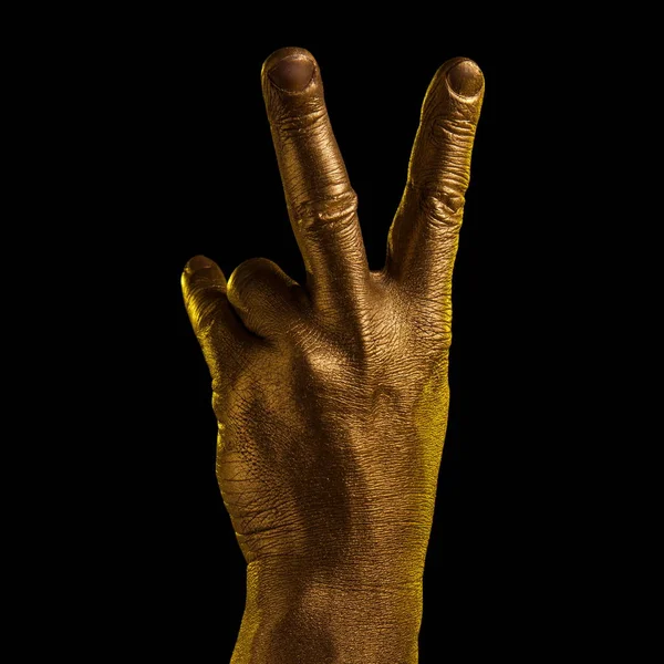 Golden hand and gesture on a black background