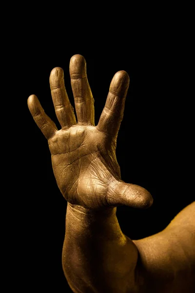 Golden hand and gesture on a black background