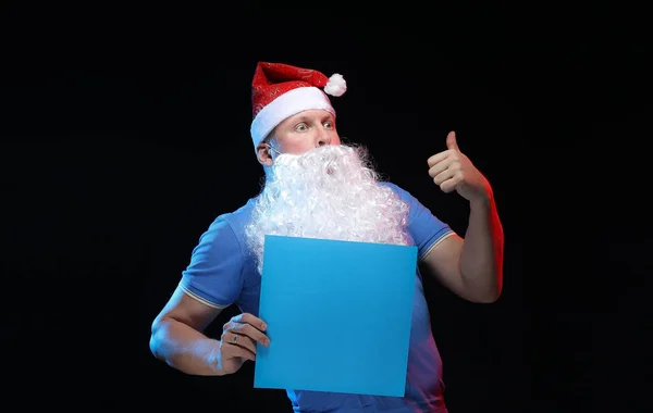 portrait actor male in cap and beard of Santa Claus on a black background