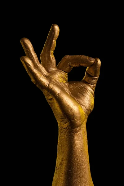 Golden hand and gesture on a black background