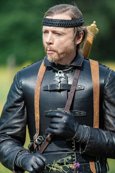 Man actor in the historical leather costume of a knight from the fantasy games