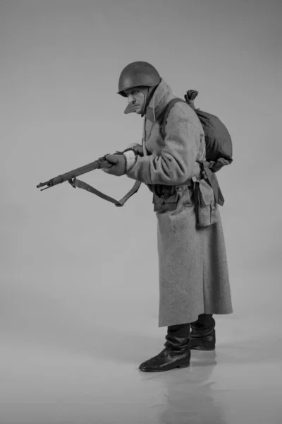 male actor movie in the role in the winter military uniform of an old soldier, the period 1942, the Second World War, posing on  background