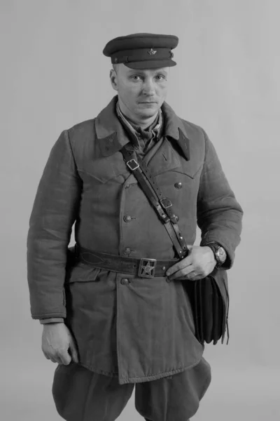 male actor in winter uniform a Russian soldier of the Red Army, a period of 1942 the second world war, posing on  background