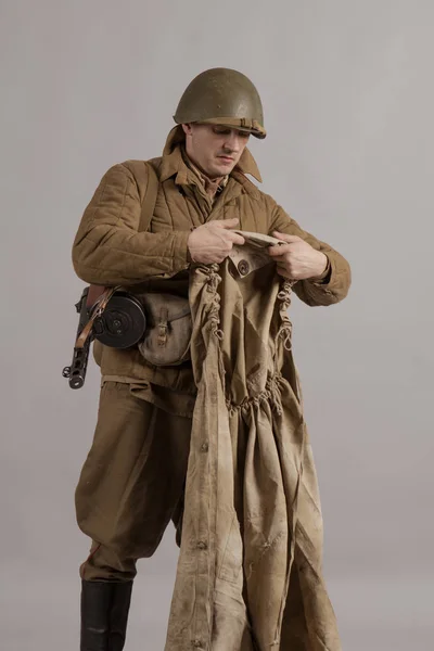 male actor movie in the role in the winter military uniform of an old soldier, the period 1942, the Second World War, posing