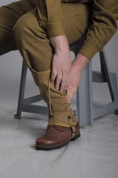 Man actor in the movie role of an old military man posing against grey background