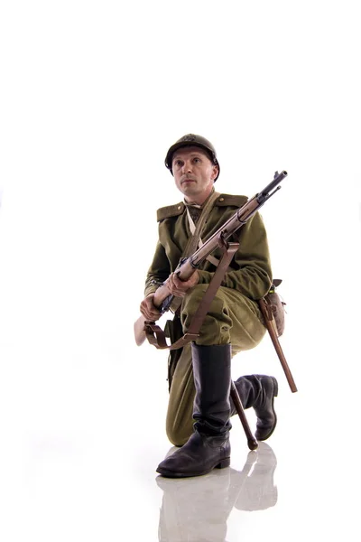 Male actor in form of ordinary soldier of Russian army during First World War posing in studio