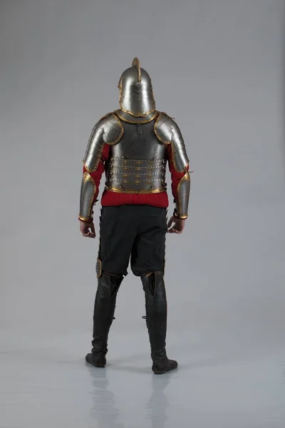 Man in armor of hussar legion posing on gray background. Character for computer game