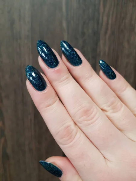 close up of female hand with fresh colorful manicure