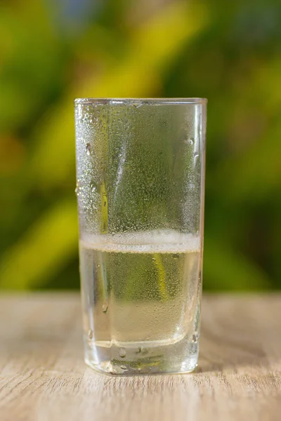 Transparent misted glass with water on table outdoors