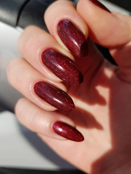 close up of female hand with fresh colorful manicure