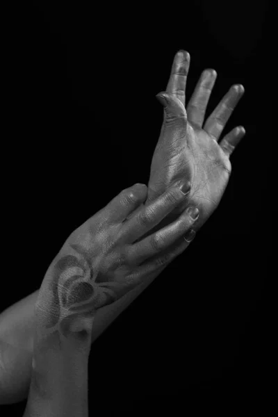 Female hands body-art. Silver skin with a black pattern.