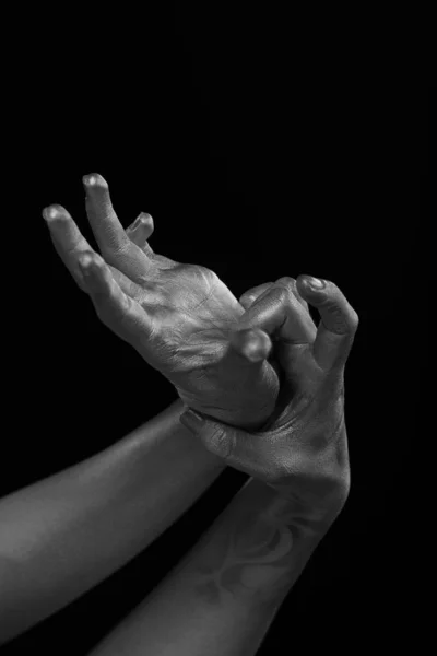 Female hands body-art. Silver skin with a black pattern.