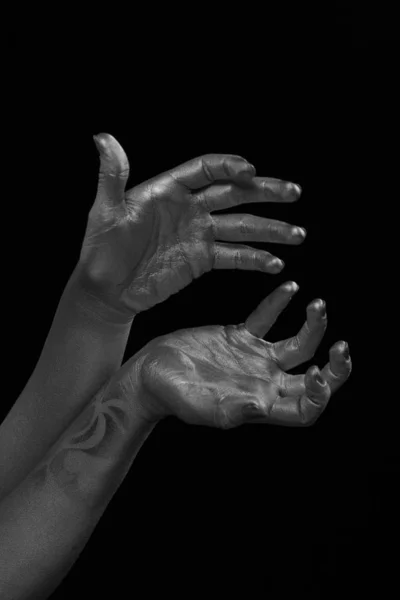 Female hands body-art. Silver skin with a black pattern.