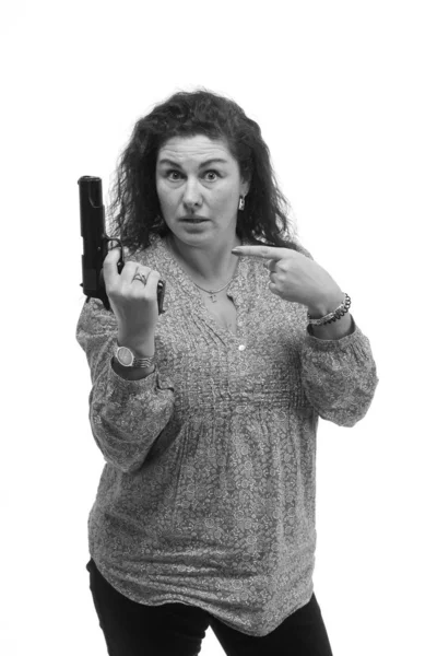 attractive emotional middle aged woman posing with gun isolated on white background