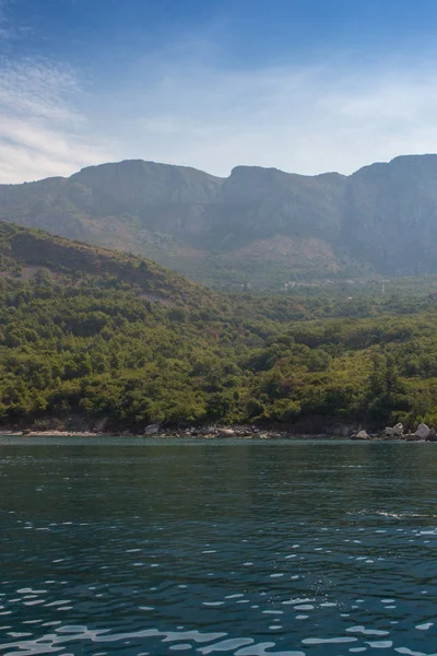 Background for design, Seascape, blue sea and mountains in misty haze