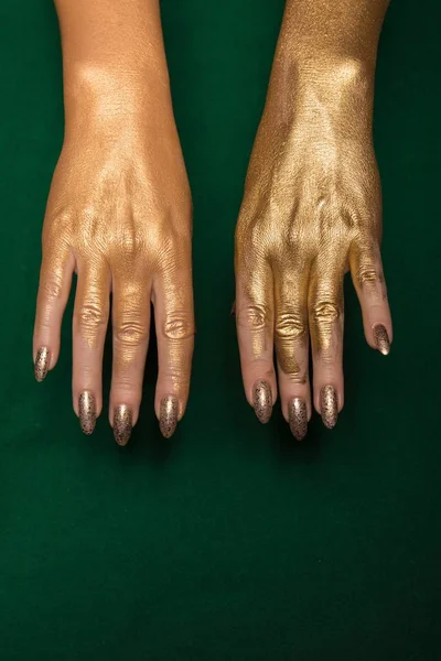 female Golden hands  on  background