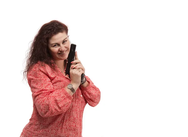 attractive emotional middle aged woman posing with gun isolated on white background