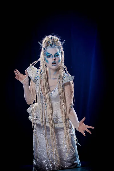 emotional actress woman in makeup and costume of the Snow Queen
