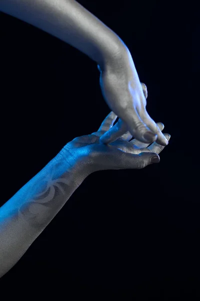 Female hands body-art. Silver skin with a black pattern.