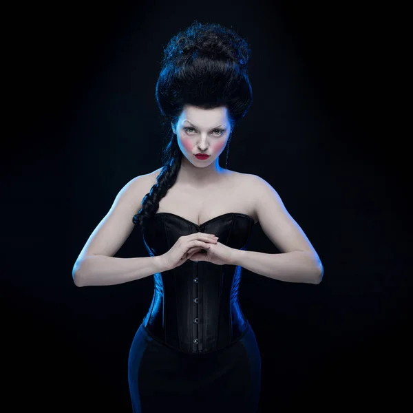 emotional actress brunette woman with pale skin in role of vampire on black background