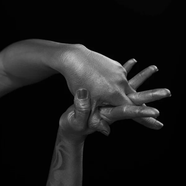 Female hands body-art. Silver skin with a black pattern.