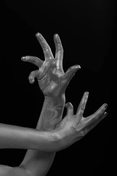 Female hands body-art. Silver skin with a black pattern.