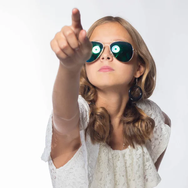 beautiful emotional girl actress in white dress and sunglasses posing in studio on white background