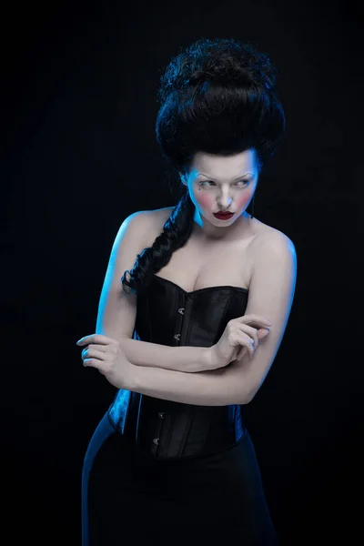 emotional actress brunette woman with pale skin in role of vampire on black background